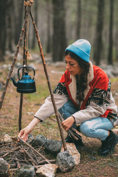 istock Young Woman Burning Fire in the Camp 1371166384