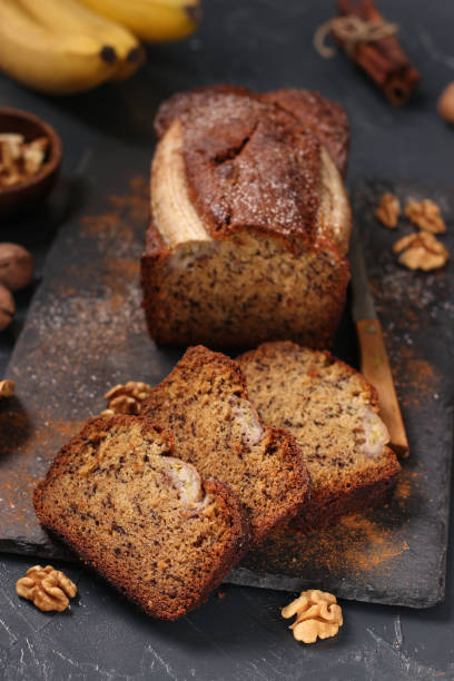 istock Homemade banana bread with walnut and cinnamon on a dark background 1371168134