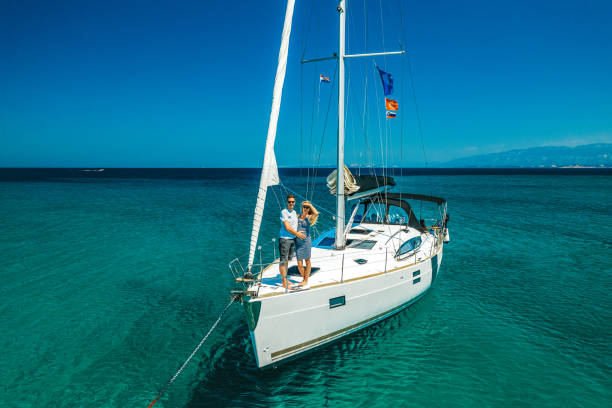 istock Couple on anchored sailboat, view from drone 1371168369