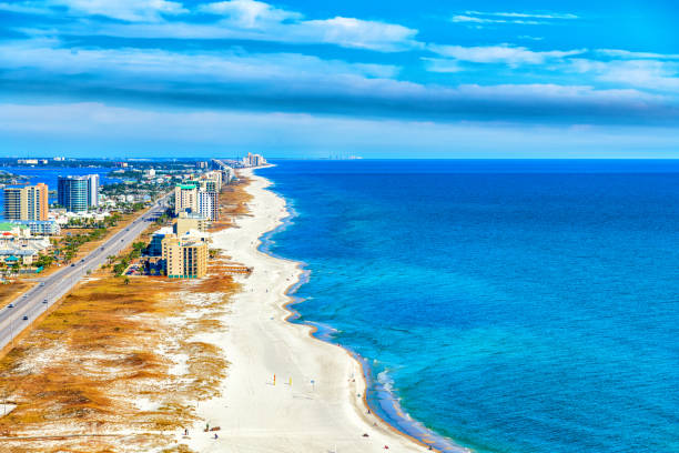 Perdido Key Beach Aerial The beach on the state line of Alabama and Florida on the Gulf Coast along Perdido Key near Orange Beach, Alabama .  The beautiful waves along the shore from an altitude of about 500 feet during a helicopter photo flight. alabama us state stock pictures, royalty-free photos & images