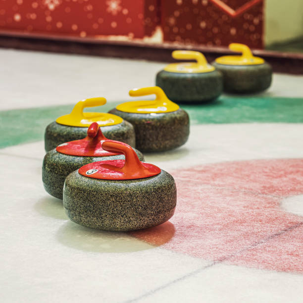 istock Group of curling rocks on ice close-up 1371172228