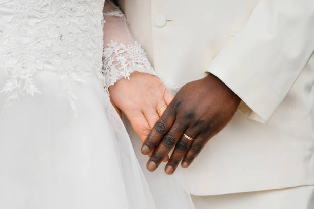 istock Causian and African couple holding hand with ring 1371173407