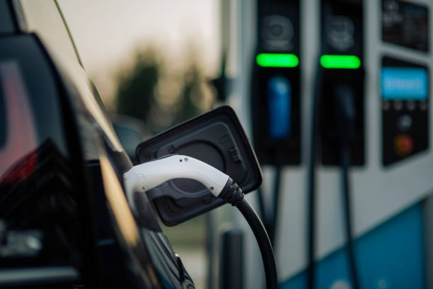 istock Electric car plug connected to the charging station 1371174422