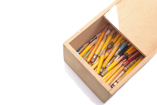 Pencils of various sizes inside a wooden box where the writer keeps it. Image taken on a white background in the studio digitally with a Nikon D610 camera and a 50mm f-stop 1.8 Nikkor lens