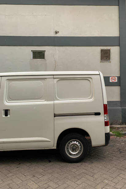istock the back of a white van beside the building 1371181673