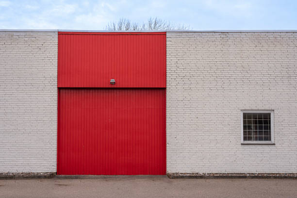 istock a red gate on the facade of a white brick building 1371181726