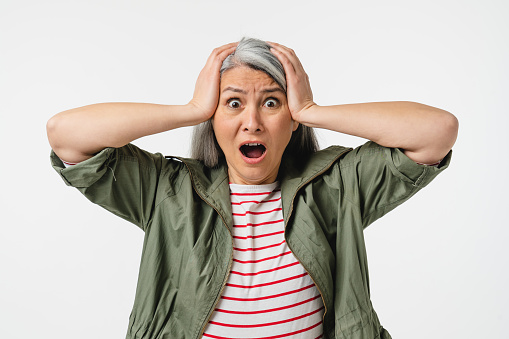 Shocked impressed crying mature middle-aged caucasian woman shouting, feeling scared terrible horrible, fear isolated in white background. Sale discount offer concept
