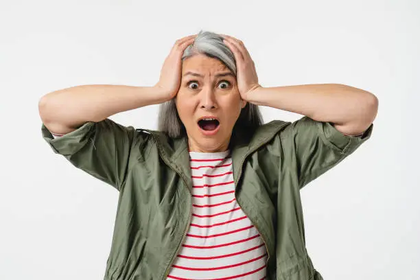 Photo of Shocked impressed crying mature middle-aged caucasian woman shouting, feeling scared terrible horrible, fear isolated in white background. Sale discount offer concept