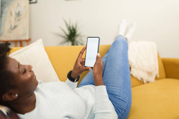istock Woman using smartphone at home 1371183398