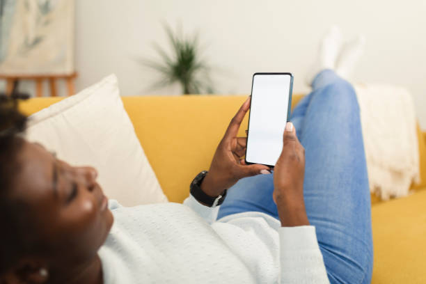 istock Woman relaxing at home and using smartphone 1371183403