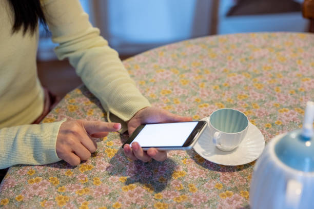 istock Woman ordering something and making reservation through smart phone app dining room 1371185930