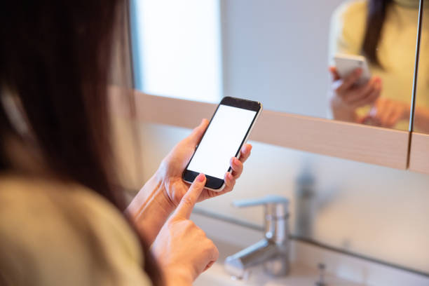 istock Woman ordering something and making reservation through smart phone app at bathroom 1371186113