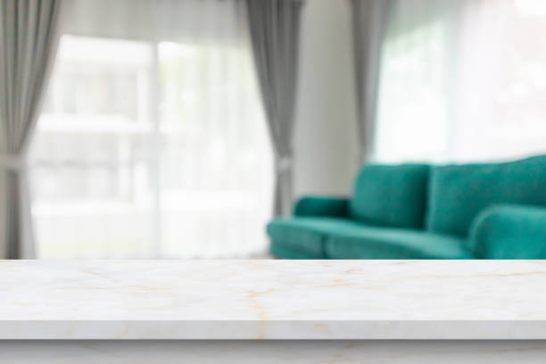 istock Empty marble table top with blur room interior with window curtain background 1371188474