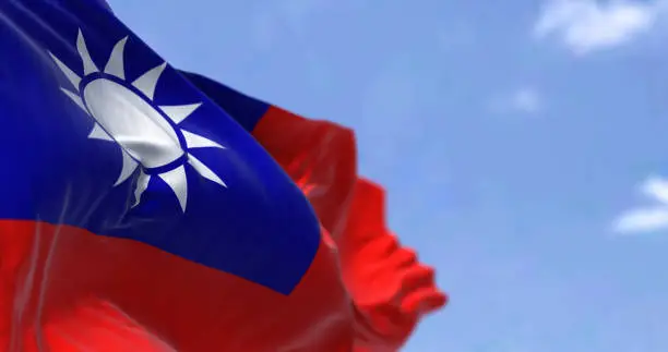 Detail of the national flag of Taiwan - Republic of China waving in the wind on a clear day. Democracy and politics. Patriotism. East asian country. Selective focus.