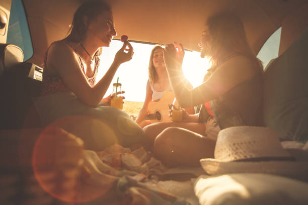 istock Three best friends having fun at the back of a vehicle while camping during summer 1371189792