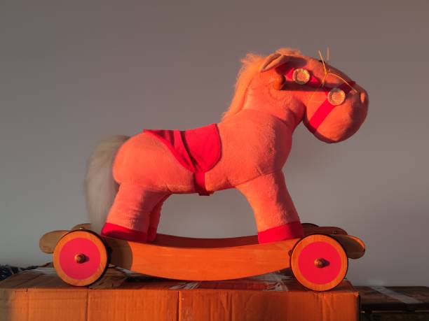 istock pink stuffed rocking horse with lateral illumination from the sun during sunset 1371190652