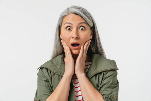 istock Surprised shocked impressed crying mature middle-aged caucasian woman shouting, feeling scared terrible horrible, fear isolated in white background. Sale discount offer concept. Bad sad news 1371190726