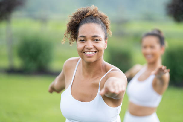 istock Women Practicing Yoga Outside 1371196340