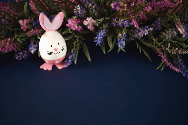 Cute Easter bunny with bouquet of lavender sprigs with space for copy