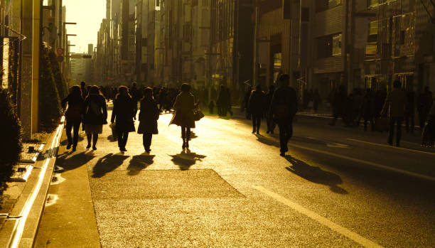 istock Crowd walking in the sunlight at dusk 1371199037