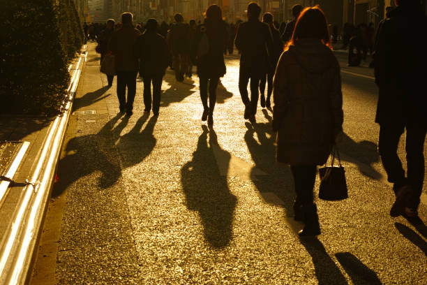 istock Crowd walking in the sunlight at dusk 1371199038