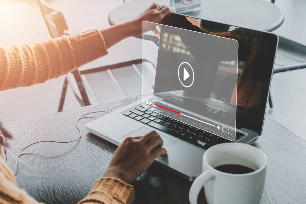 Woman watching online movie or TV series on laptop computer Video streaming on internet, Woman watching online movie or TV series on laptop computer, Concept about subscription based live digital stream. watch stock pictures, royalty-free photos & images