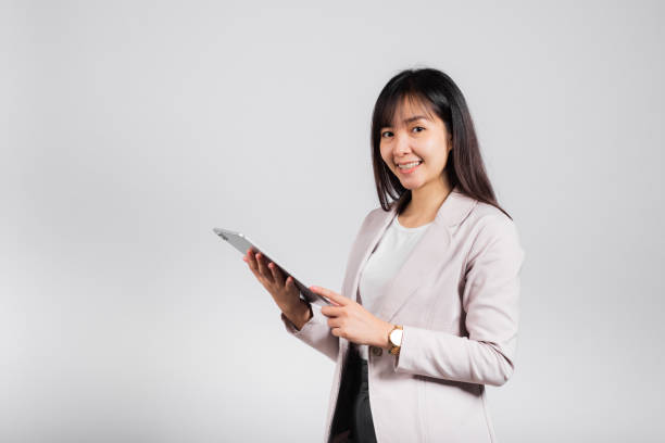 istock Portrait of Asian beautiful young woman smiling using tablet computer 1371201400