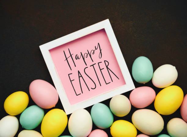 istock Happy Easter message on a dark background with collection of pastel colored Easter eggs 1371204449