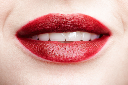 Closeup macro portrait of female part of face. Human woman red smiling, lips with day beauty makeup. Girl with perfect lips shape.