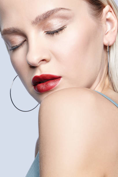 istock Blonde female with closed eyes on gray background. 1371207930
