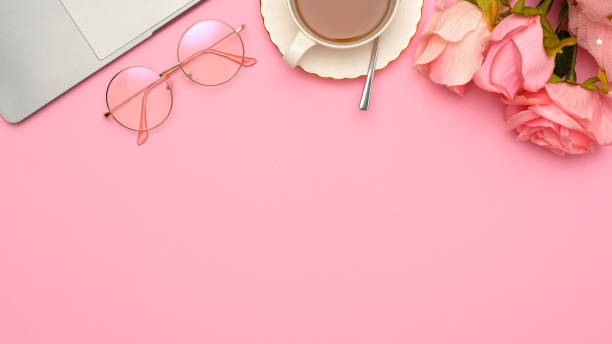 istock Copy space with laptop, eyeglasses, teacup and roses on pink background. 1371208732