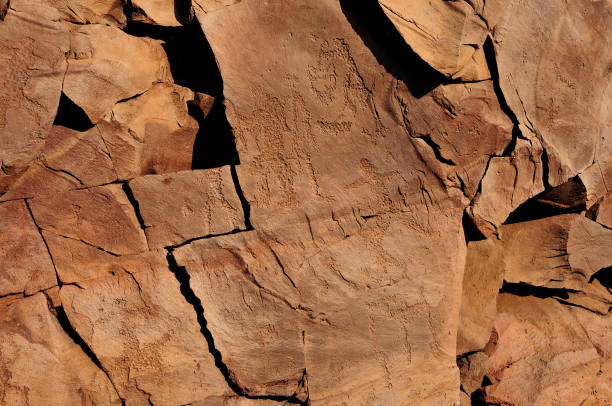 Ancient rock paintings on a flat vertical surface of a red mountain. Ancient rock paintings on a flat vertical surface of a red mountain. Mountain range Chests, Khakassia, Siberia, Russia. boulder mountains stock pictures, royalty-free photos & images