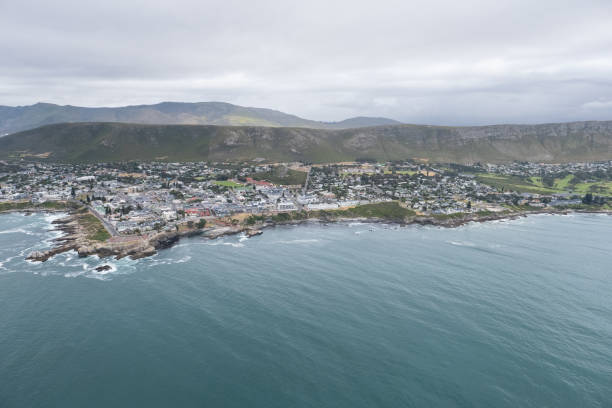 Drone shot over Hermanus in the Western Cape Aerial shot looking down towards the town of Hermanus near Cape Town. Small coastal town hermanus stock pictures, royalty-free photos & images