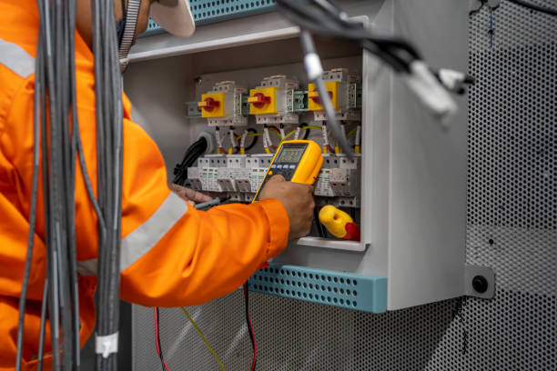 engineer is installing an electrical system in a control room in a factory. energy concept, factory stock photo