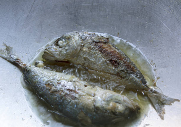 istock Mackerel fried in boiling oil in a hot pan. 1371216328