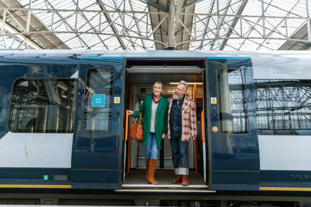 istock Stylish senior couple exiting train 1371218062