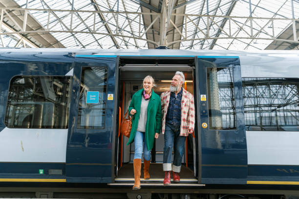 istock Stylish senior couple exiting train 1371218068