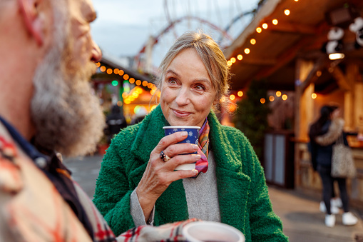 Enjoying a hot drink at winter street festival