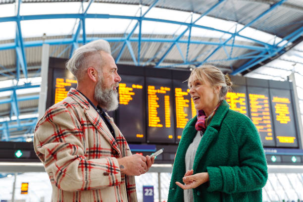 istock Happy senior couple chatting in train station while on vacation 1371218141