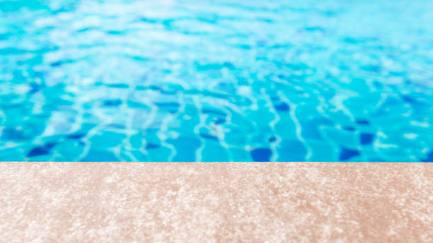 istock Side of swimming pool with water ripple texture background and copy space 1371219101