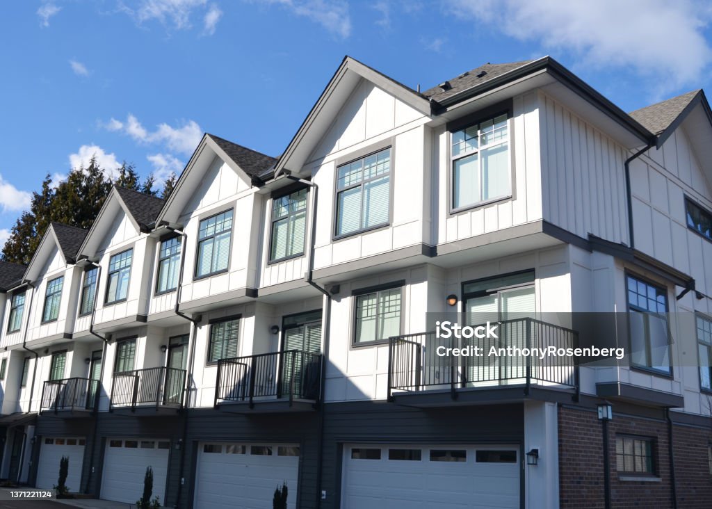 Townhomes Looking at new townhomes from the street in the sunshine in suburban Vancouver, B.C. Townhouse Stock Photo