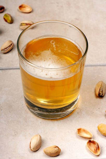A glass of beer and pistachios stock photo
