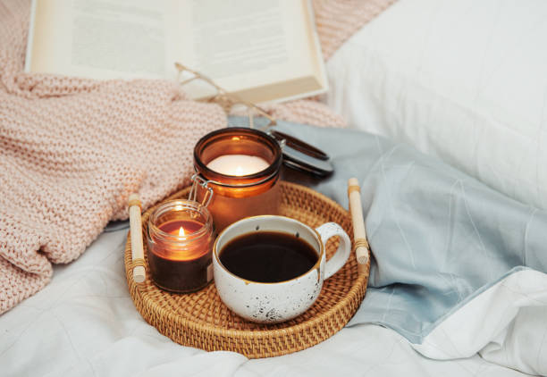 istock Tray of coffee and candles on bed. 1371226708