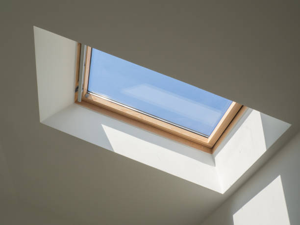 istock dormer wooden window in the white sloping ceiling overlooking the blue sky 1371228520