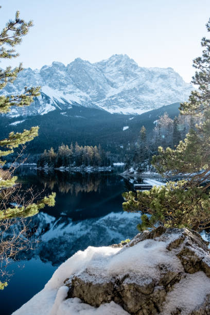 View on the Zugspitze from the Eibsee in the winter Winterwonderland at the Eibsee a little lake close to the Zugspitze in Bavaria bavarian forest stock pictures, royalty-free photos & images