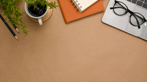 istock A brown workspace background with office supplies and copy space. 1371231674