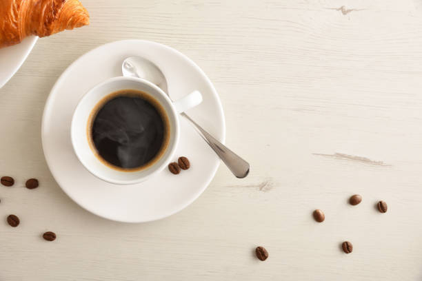 istock Cup with hot coffee on white table at breakfast top 1371232378