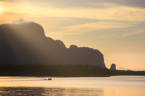 Evening view of a boat tour in the Sea and Landscape at the Ao Phang Nga Nationalpark on the Andaman Sea in the south of Thailand.