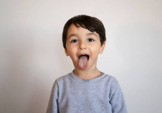 Portrait of a funny little boy making face.