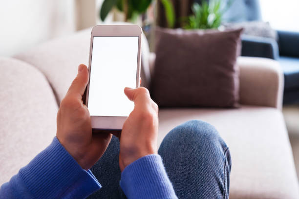 istock Woman using mobile phone at home and lying down at sofa 1371238606
